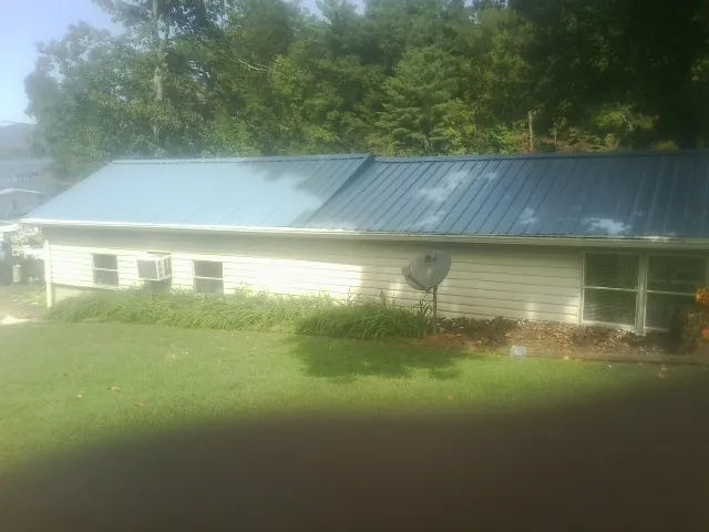 Blue metal roof running the length of a single story home in Carnesville